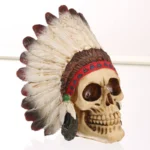 SKULL FIGURINE FEATURING A NATIVE AMERICAN-STYLE FEATHERED HEAD - Image 3