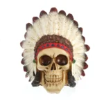 SKULL FIGURINE FEATURING A NATIVE AMERICAN-STYLE FEATHERED HEAD